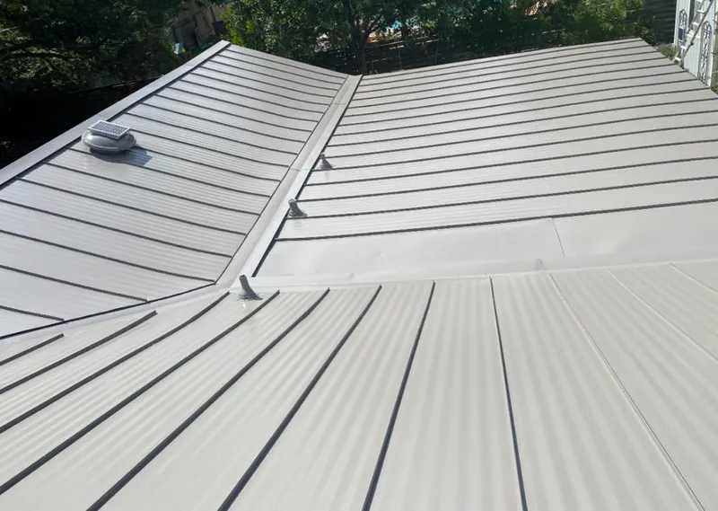 Solar attic fan installed on a metal roof for Roof Ventilation in Mequon